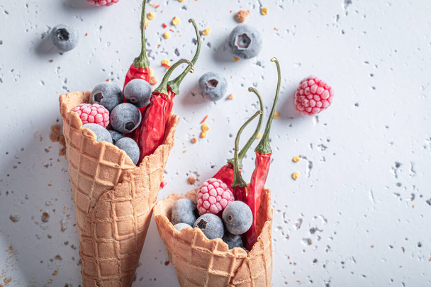 Spicy ice cream with berries and chilli. Unique icecream. New flavors of ice cream.  - Photo, image