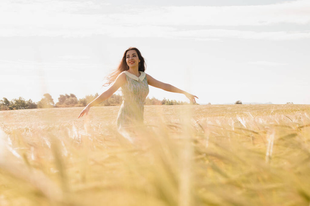 Woman happy on nature wheat meadow on summer day. Positivity and happiness attitude in life.  - Fotoğraf, Görsel