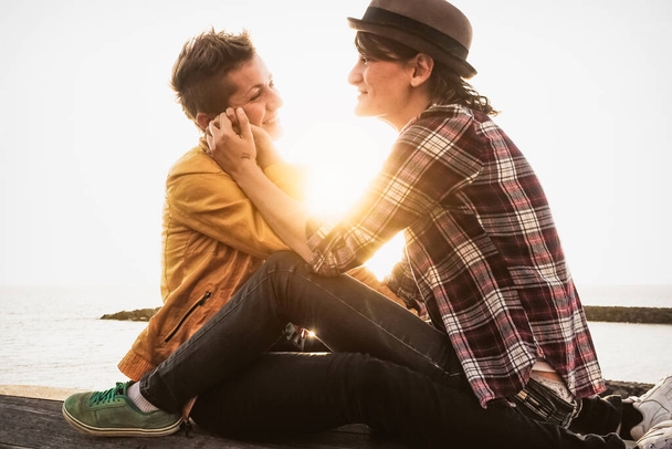 Šťastný homosexuální pár s něžné momenty u moře při západu slunce - homosexuální milostný vztah a rovnost pohlaví koncept - Fotografie, Obrázek