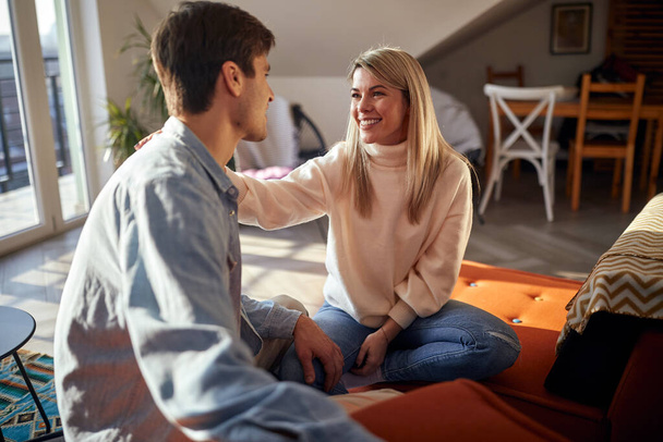 A young couple in love having a lovely talk in a relaxed atmosphere at home. Couple, love, home, relationship - Foto, imagen