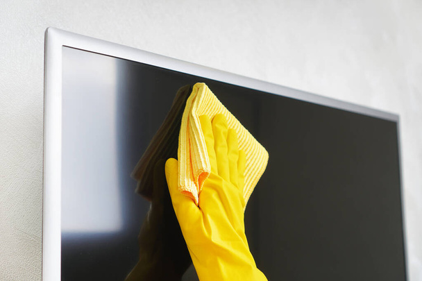 Cleaning service. Cleaning dust from the TV screen. - Photo, Image
