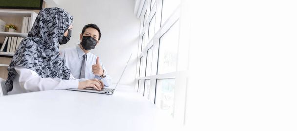 copy space. asian business people group wearing protection face mask working and communicating at modern office desk together, digital creative online marketing and business meeting startup concept - Fotó, kép