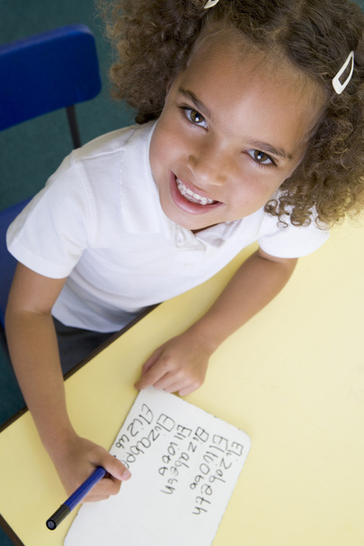 Girl learning to write name in primary class - Photo, Image