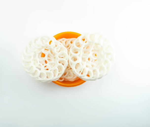 Krupuk or Kerupuk, traditional Indonesian crackers, placed in an orange bowl on a white background. - Photo, Image