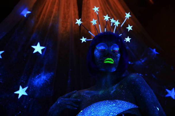 Neon visage. Beautiful girl in the image of the month with stars - Foto, imagen