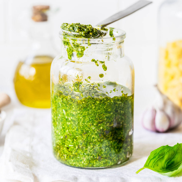 Pesto Sauce with  Ingredients: Fresh Basil, Pine Nuts, Olive Oil and Cheese, square - Valokuva, kuva
