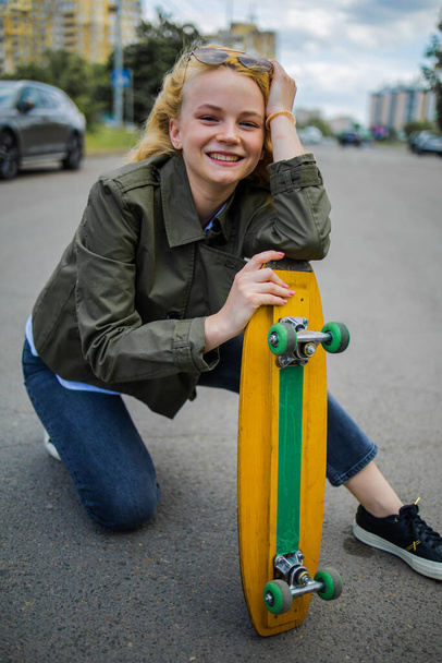 Smiling Teenage Girl Riding Skate Outside - Fotó, kép