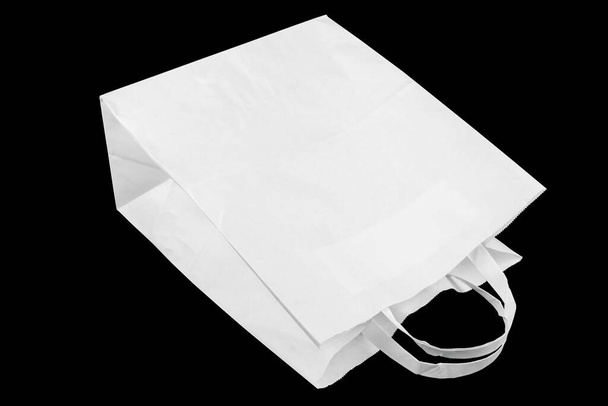 used white paper bag with handles isolated on black background - Фото, зображення