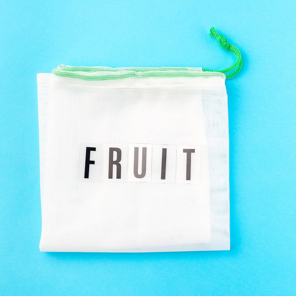 Reusable bag for fruits on a blue background, zero waste or plastic free concept, top view, square format - Foto, immagini