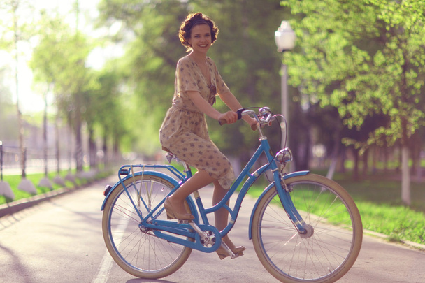 Girl with bicycle in park - Φωτογραφία, εικόνα