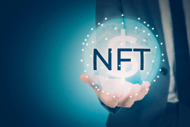 Hands of businessman holding nft world about trading currency digital with artist and art, cryptocurrency and technology blockchain, virtual interface, trend globe, business futuristic concepts. - Photo, Image