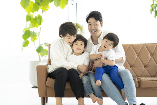 Asiatische Familie tobt auf der Couch  - Foto, Bild