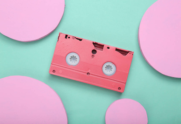 Creative minimal layout. Video cassette with circles on mint blue background. Minimalism. Concept art. Flat lay. Top view. - Foto, Imagem