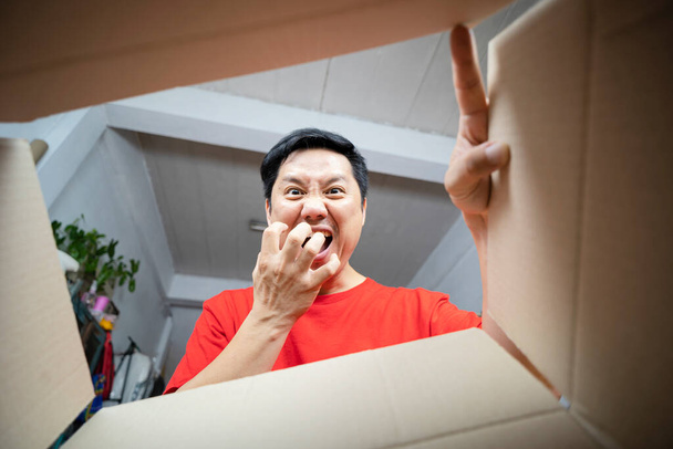 The man was looking into the box excitedly excited about the gift. Products delivered to the house - 写真・画像
