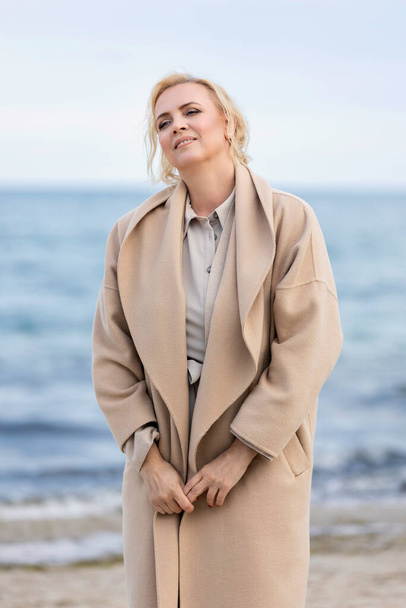 Woman in coat by the sea - Photo, Image