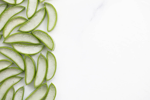 Natural green aloe vera stem cut into slices. Health and well being background - Valokuva, kuva