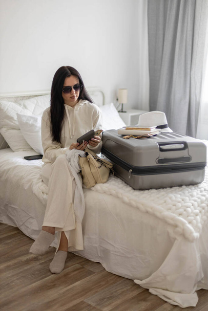 Trendy woman counting checking money cash dollar in wallet before leaving bedroom ready to travel - Fotografie, Obrázek