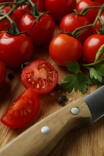 Cutting board with cherry tomato and knife, close up - Фото, зображення