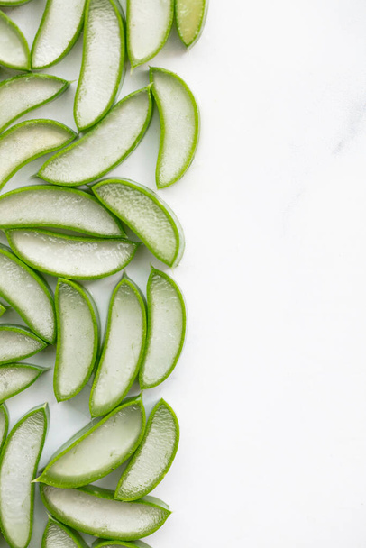 Natural green aloe vera stem cut into slices. Health and well being background - Fotoğraf, Görsel