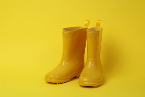Rubber boots for gardening on yellow background - Φωτογραφία, εικόνα