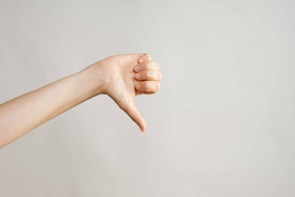 Hand gestures. Thumbs down, dislike disapproval. womens hand - Foto, Bild