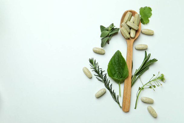 Concept of herbal medicine pills on white background, space for text - Foto, afbeelding