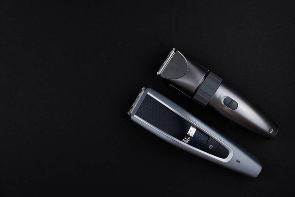 two electric hair clippers on a black background - Фото, зображення