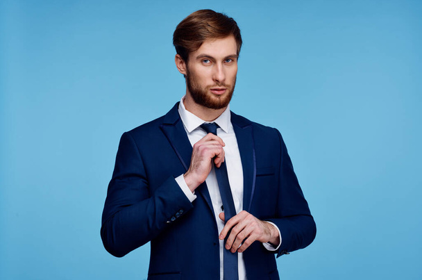 man in a suit straightens his tie self confidence fashion businessman - Valokuva, kuva