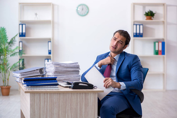Jovem empregado do sexo masculino leitura de papel contratual no escritório - Foto, Imagem