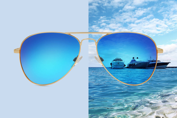aviator sunglasses isolated on blue and summer background with boats on the sea and blue sky, concept of polarized protective lenses - Photo, Image
