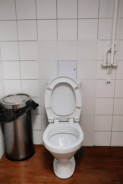 toilet in the public restroom. Simple interior.  - Фото, изображение