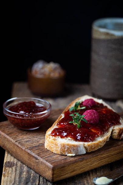 Bread with sweet raspberry jam - 写真・画像