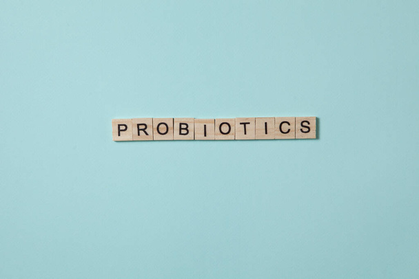 Probiotics Text by wooden letters on a green background. Concept photo. - Foto, immagini