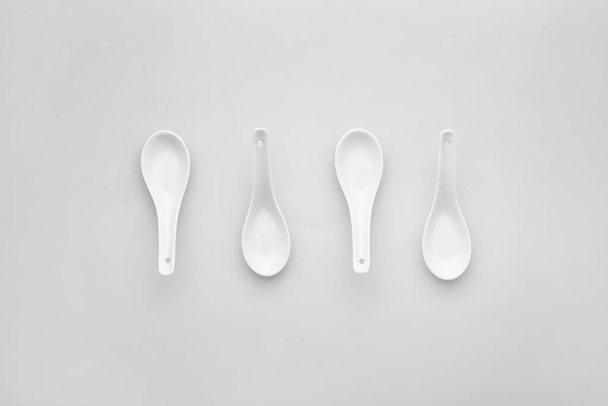 Clean spoons on grey background - Foto, afbeelding
