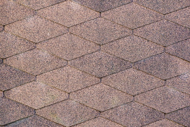 Roof covered with trapezoidal shingles close up. Modern trapezoidal roof shingles. waterproof rough surface for the outer cover of the building - Photo, Image