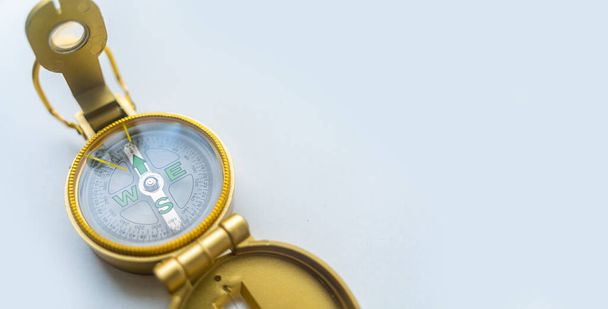 Banner of golden compass isolated, shallow DOF, focus on dial. Compass on a white background. Concept for direction, travel, guidance or assistance. Selective focus. - Foto, Bild