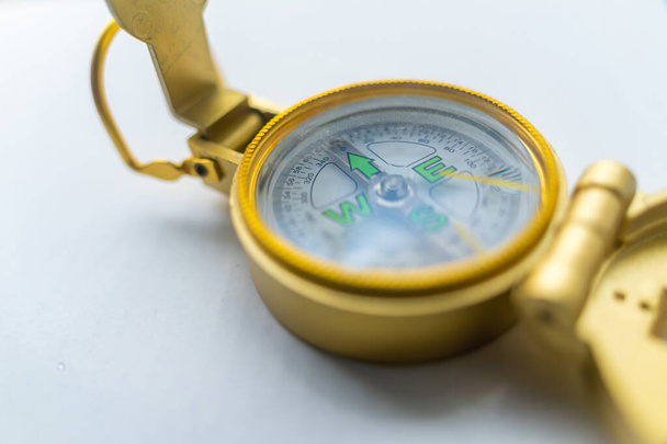 Banner of golden compass isolated, shallow DOF, focus on dial. Compass on a white background. Concept for direction, travel, guidance or assistance. Selective focus. - Fotografie, Obrázek