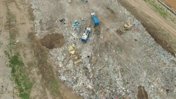 Aerial view of garbage dump or junk yard. Dump trucks unloading waste on landfill. Utilization or recycling of rubbish. - Footage, Video