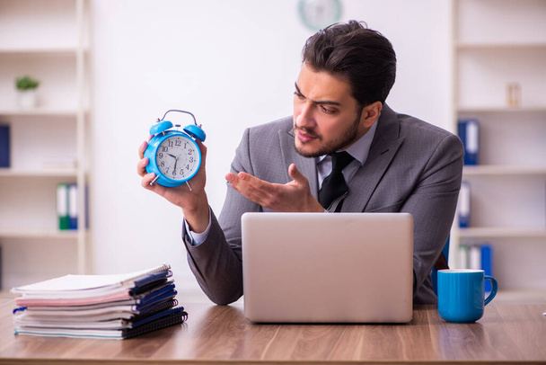 Young businessman employee in time management concept - Photo, Image