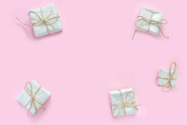 Heap of gift boxes in vintage wrapping paper on pink background. Minimal creative  backdrop for  holiday .  - Φωτογραφία, εικόνα