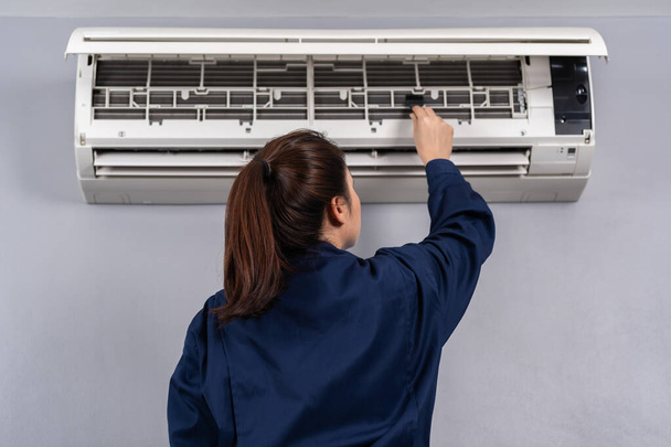 technician service using brush to cleaning the air conditioner indoors - Photo, image
