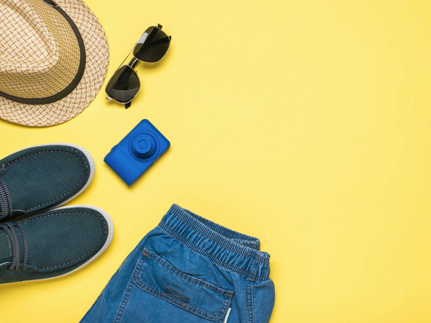 Men's accessories for leisure and travel on a yellow background. Space for the text. Flat lay. - Photo, Image