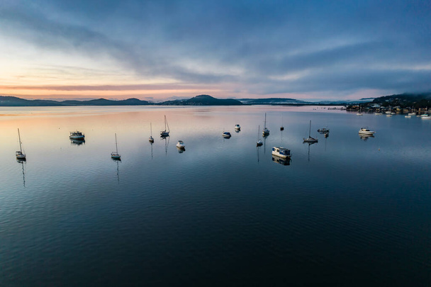 A soft pretty aerial sunrise with boats and fog at Koolewong Waterfront on the Central Coast, NSW, Australia. - Foto, Imagen