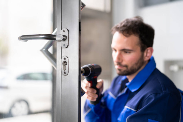 Locksmith Man Repairing And Changing Metal Door Lock - Photo, image