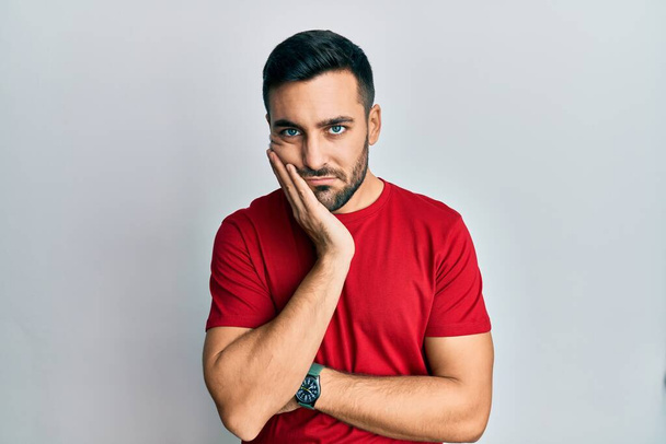 Young hispanic man wearing casual clothes thinking looking tired and bored with depression problems with crossed arms.  - Foto, Bild