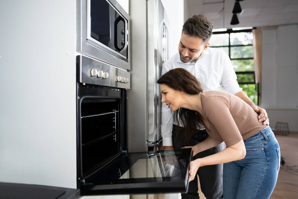 Couple Buying Electrical Oven With Consumer Loan Credit - Photo, Image