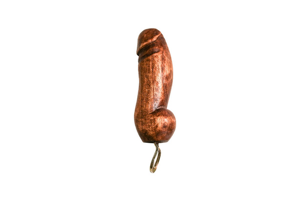 Bottle opener in the form of wooden penis isolated on white background. Souvenir from countries. - Photo, image