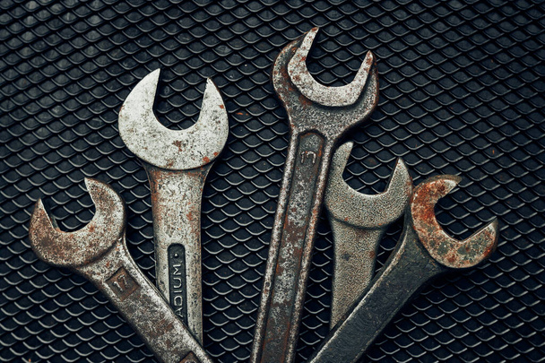 Spanners on steel surface. Old rusty wrenches for maintenance. Mechanic hardware tools to fix. Technical tools background with copy space - Photo, image