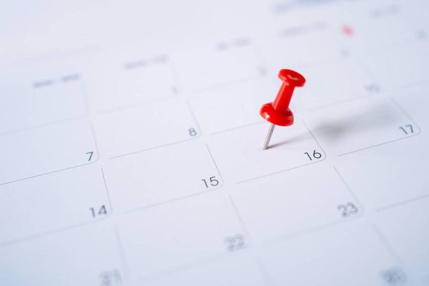Selective focus. Picture of red pin embroidered on June 16 in the calendar. Concept of to do planning. - Photo, Image