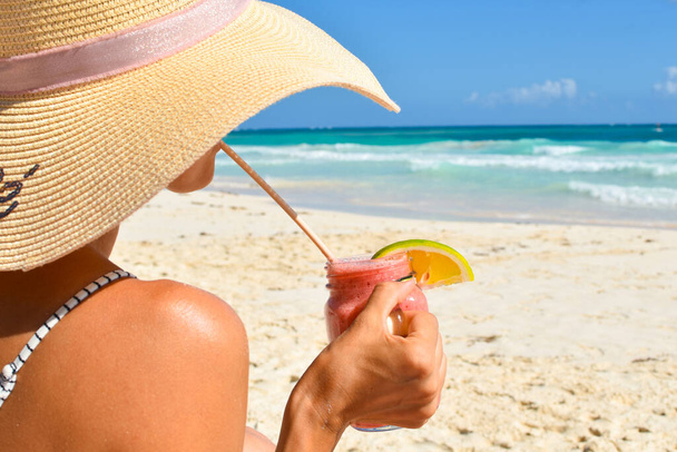 beautiful woman on the beach in summer sunbathes. calm seaside vacation. - Fotó, kép